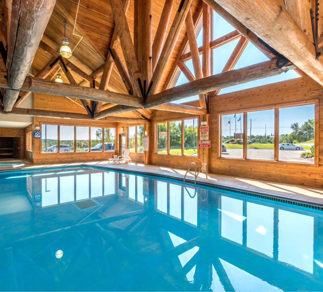 Indoor pool with rustic feel at Grand Ely Lodge