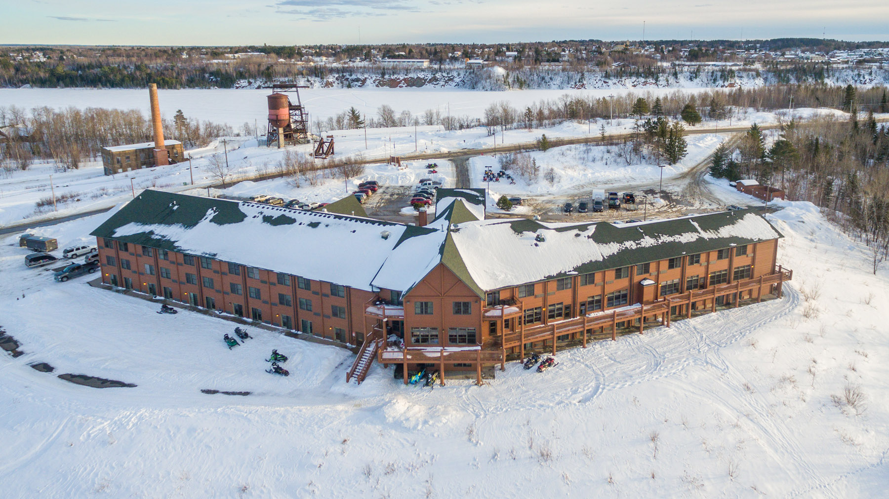 Aerial view of Grand Ely Lodge Resort covered in snow in winter.