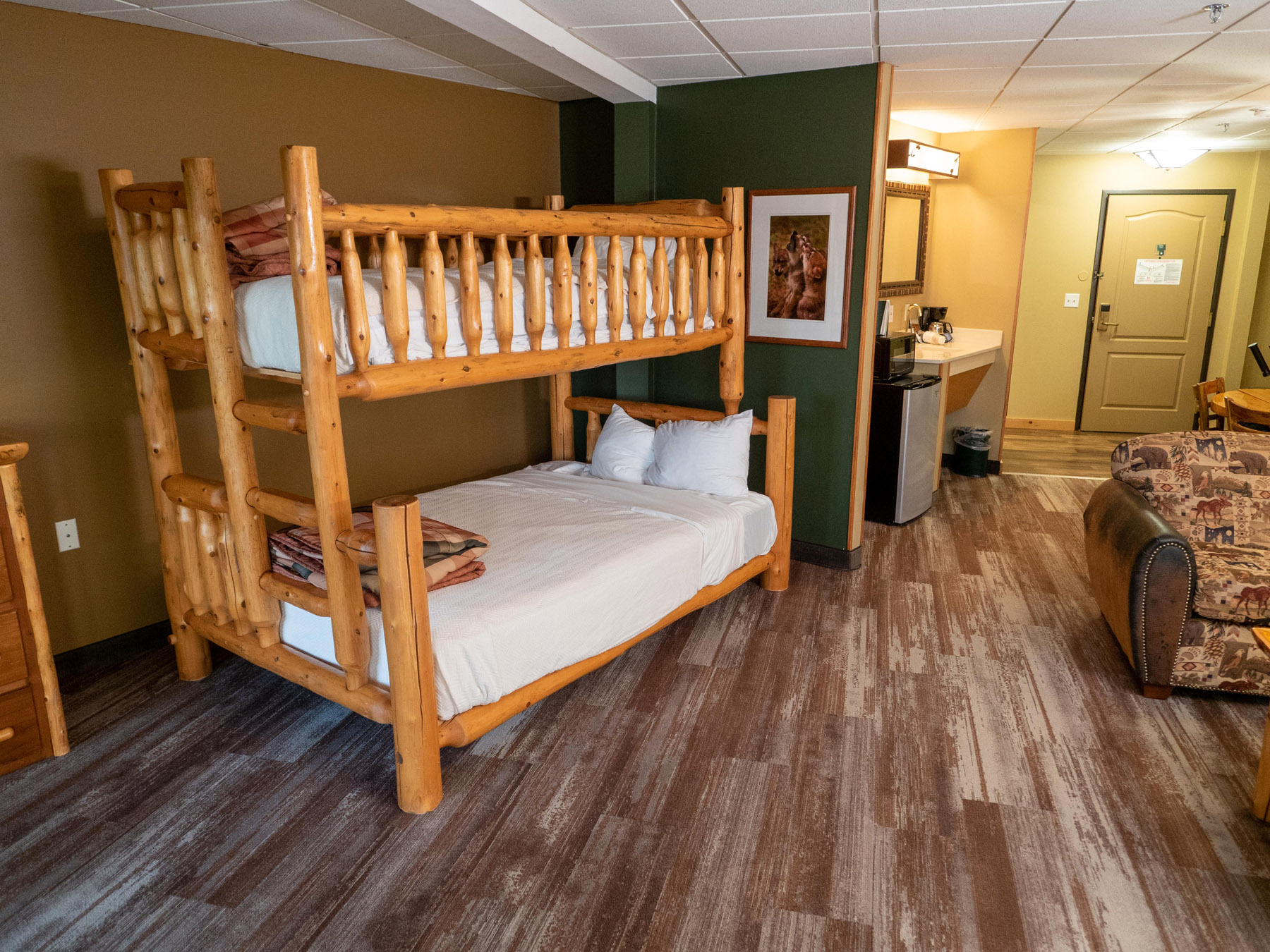 Kids' one-room suite with wooden bunk beds and couch