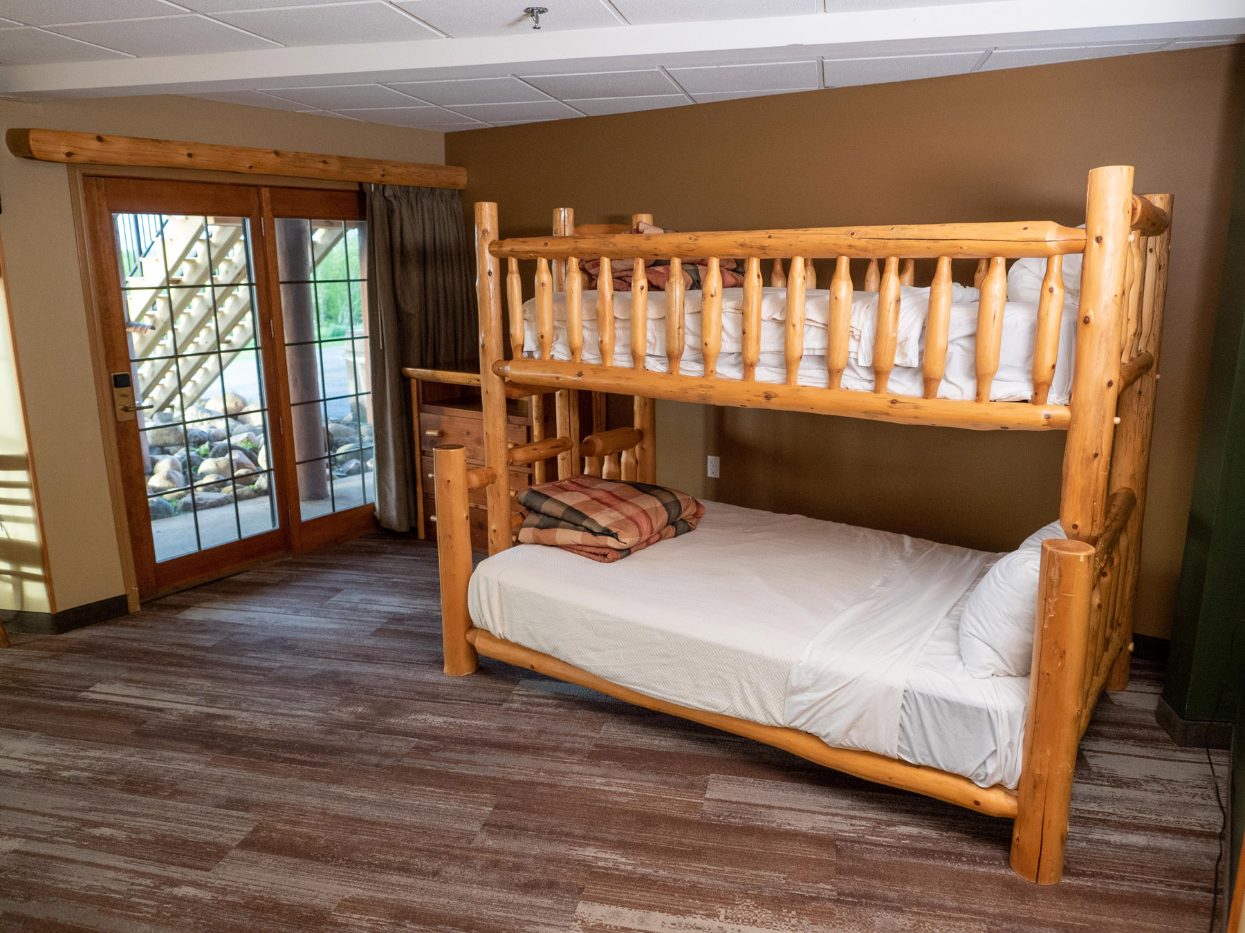Kids' one-room suite with wooden bunk beds and couch