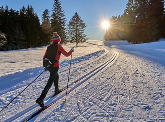 A boat sits at a dock during sunset